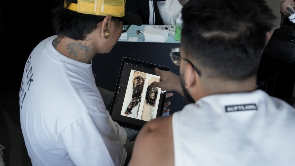 Tattoo artist discussing design and placement with a client in Bali